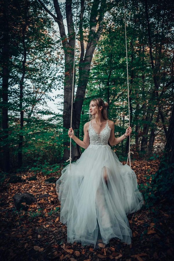 Bride on a swing in an autumn forest