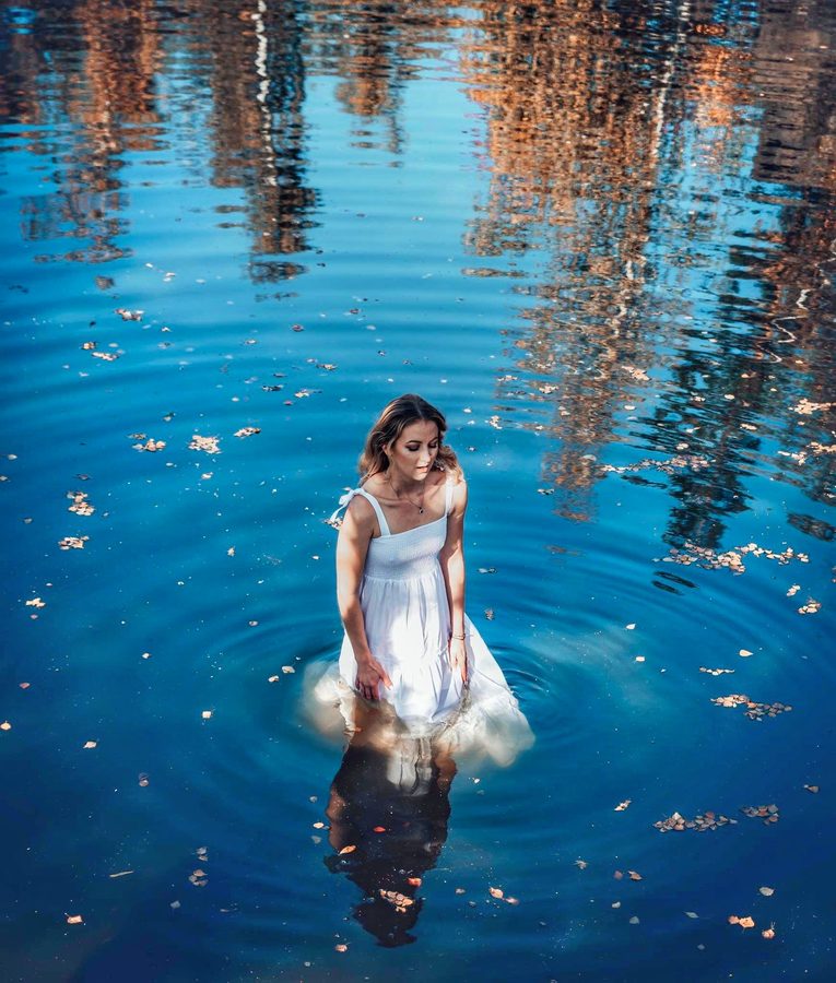 Bride standing in blue water