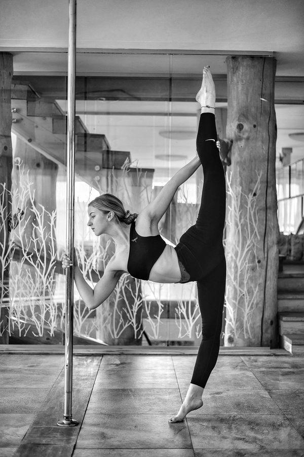 Standing split on a pole, black and white